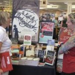 Rhoda Wolff and Whitney Spotts of Schuler Books check the Mockingbird exhibit