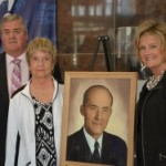 Daughter of Ralph Crego (second from left) with her father's portrait